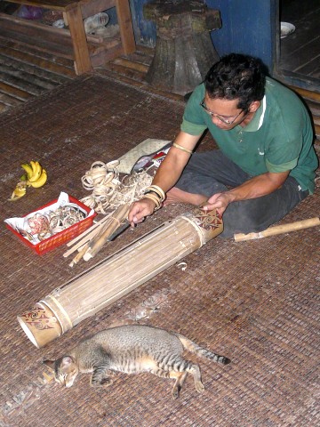 Saram demonstrating bamboo instrument